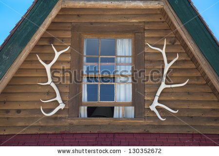 stock-photo-elk-antlers-as-design-feature-on-log-cabin-130352672